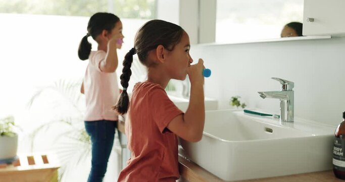 Children brushing teeth for dental care in the bathroom of their modern family home together. Hygiene, oral health and girl kids doing a clean morning mouth routine for wellness in their house.