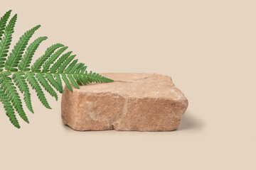 Stone Podium for promotion on neutral beige Background. Natural stone pedestal. Green Palm fern leaves. Beauty product mockup. Cosmetics, Soap Stand. Showcase, display case. Soft shadow. One Form 3d