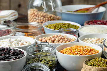 White ceramic bowls with assorted grains on kitchen table