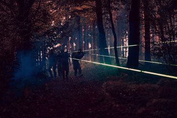 Soldiers squad in action on night mission using laser sight beam lights military team concept