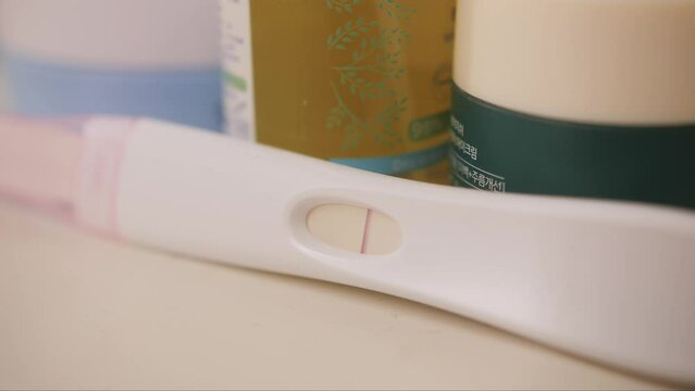 Pregnancy negative test on shelf in bathroom close up.