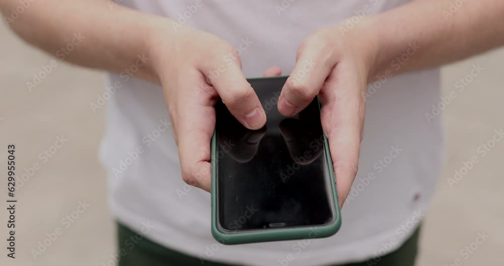 Aufkleber close-up hands of unrecognizable man typing online message using mobile phone