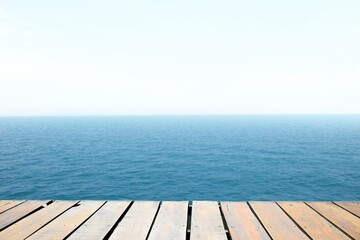 wooden floor, blue sea and sky