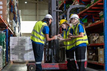 Man and woman warehouse worker team discussing and preparing move goods in package boxes to shelf or rack by forklift truck at storage factory. Logistics, Distribution Center concept.