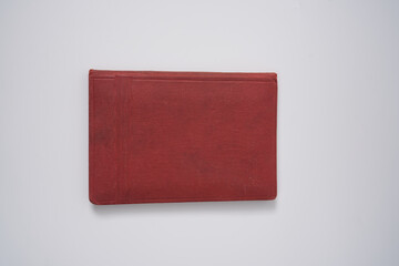 Old red notebook from 1950's on a white background.