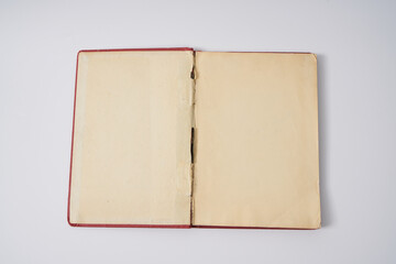 Old red notebook from 1950's on a white background.