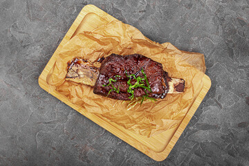 grilled meat on the bone with fresh herbs