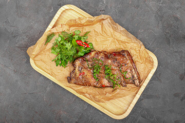 grilled pork ribs on a wooden board