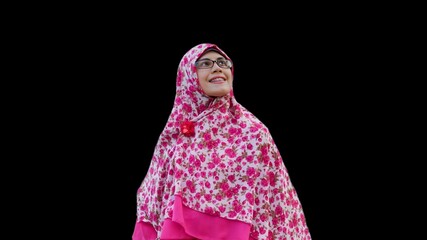 Close up portrait of smiling young Muslim woman wearing long hijab with flower motif looking up. Happy and self confidence expression.