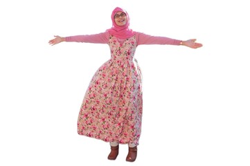 Portrait of smiling young Muslim woman wearing pink hijab with red rose flower motif dress spreading left and right arm wide open gesture. Happy and cheerful expression.