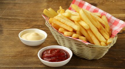 french fries in a basket with sauce