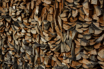 Log background. Vibe village. Beautifully laid out logs for the fireplace and stove.