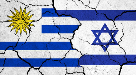Flags of Uruguay and Israel on cracked surface - politics, relationship concept