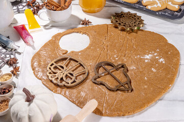 Cooking baking Halloween gingerbread cookies. Preparing for Halloween party holiday, mom and child...