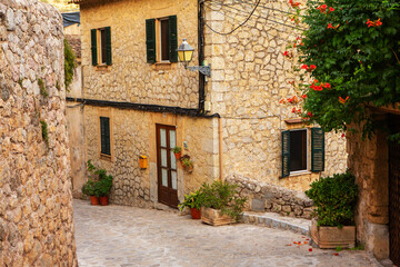 Fototapeta na wymiar View of a medieval street of the picturesque Spanish-style village Valdemossa in Majorca or Mallorca island, Spain.