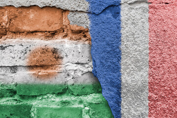 Niger and France. French and Nigerian flag. Flags of countries on background of brick wall. Street...