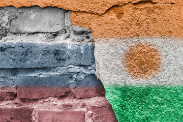 Russian and Nigerian flag. Street art. Flags of countries on background of a brick wall. Niger and...