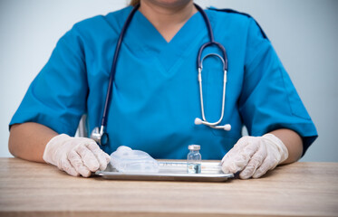 Medicine doctor is filling the medical syringe. Physicain is dawing medicine solution for her...