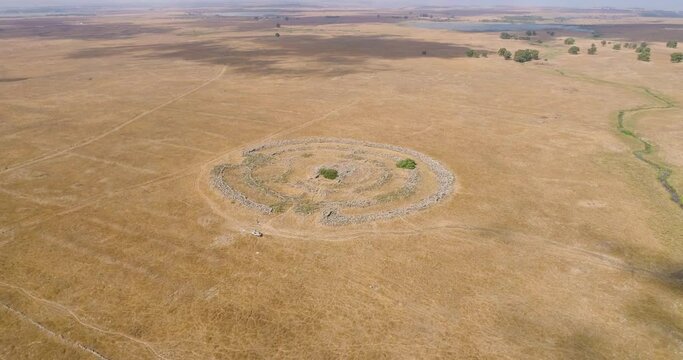 Aerial view of ancient megalithic monument site in the shape of 3 concentric stone circles, Rujum Al-Hiri, Golan Heights, Israel.