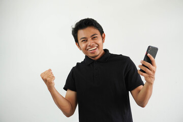 Excited happy young asian man winner feeling joy using smartphone winning lottery game, betting,...