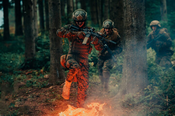 Soldier in Action at Night in the Forest Area. Night Time Military Mission jumping over fire