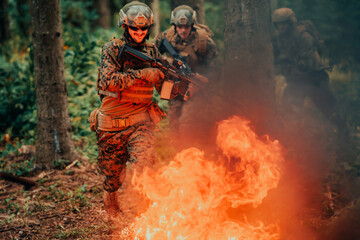 Soldier in Action at Night in the Forest Area. Night Time Military Mission jumping over fire