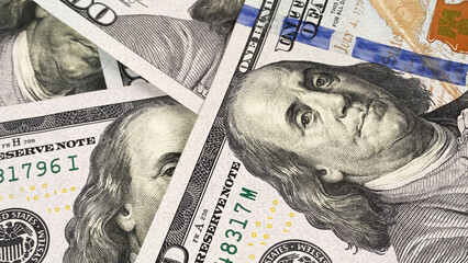 Close-up portrait of Benjamin Franklin. Cash banknotes. One hundred US dollars. The American national currency. $100 bills. Background of cash dollar bills.