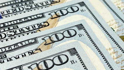Close-up of $100 cash banknotes. Background of cash dollar bills. One hundred US dollars. Background of money. The American national currency.