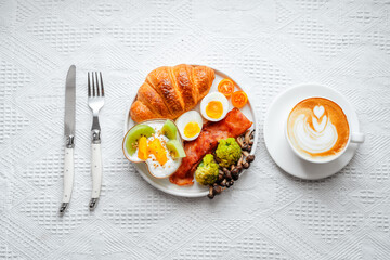 Breakfast croissants with yogurt, boiled eggs and bacon.