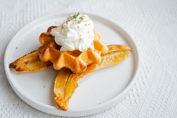 Waffels with banana and whipped cream