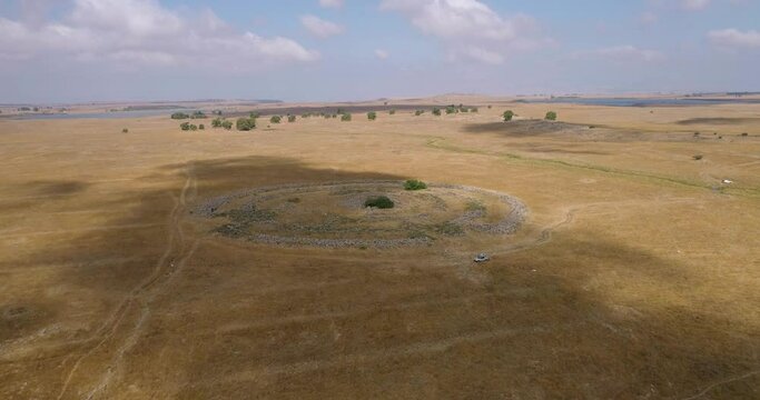 Aerial view of ancient megalithic monument site in the shape of 3 concentric stone circles, Rujum Al-Hiri, Golan Heights, Israel.