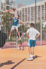 Street basketball game. Basketball shield, Basket and ball. Basketball player throwing ball into basket