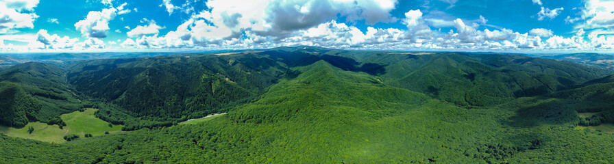 Obraz premium Panoramic landscape with green forested hills of the Carpathian mountains seen from above