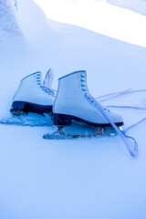 Figure skates over snowy background with copy space