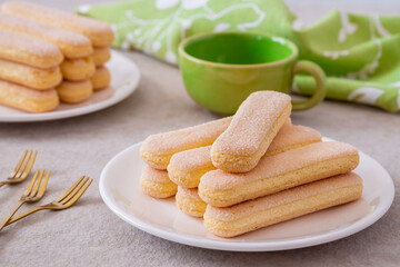 Fototapeta na wymiar Lady finger biscuits, Italian dessert and sponge cookie on white plate and coffee cup
