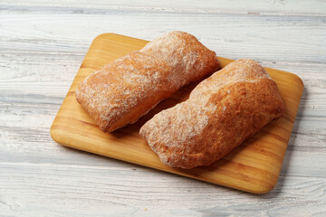Two bread buns on wooden board close up
