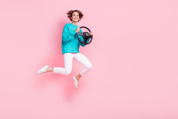 Full body photo of attractive young woman jumping hold steering wheel wear trendy blue clothes...