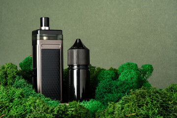 Vape smoking liquid bottles on moss background