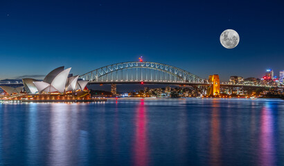 Fototapeta na wymiar Panoramic night view of Sydney Harbour and CBD buildings on the foreshore in NSW Australia