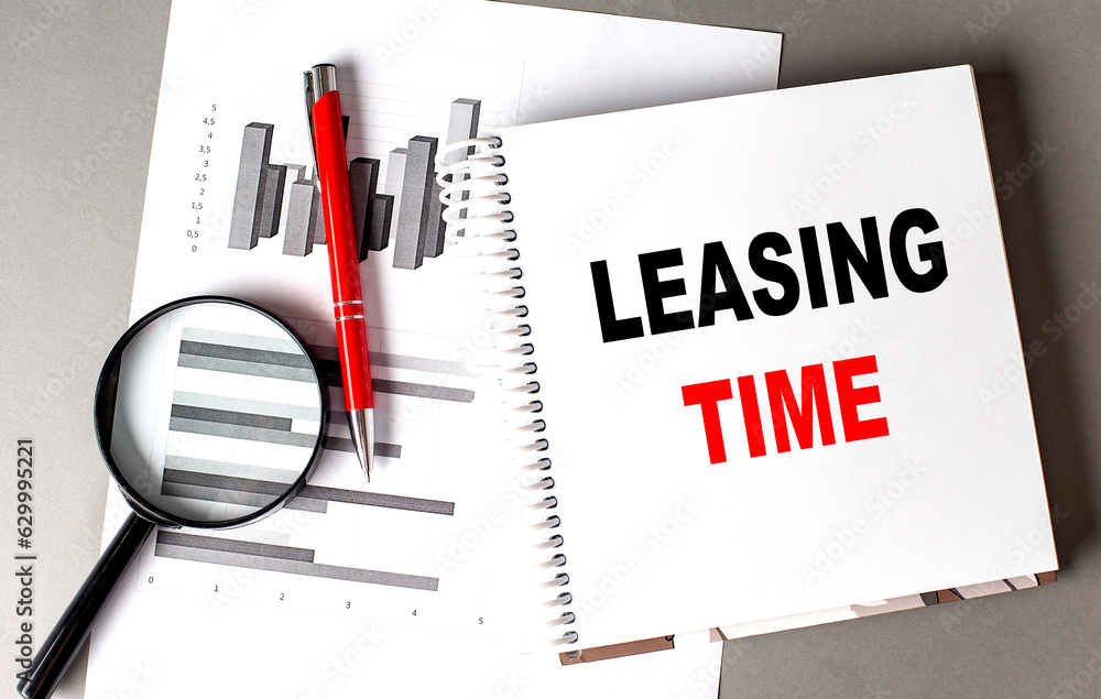 Poster leasing time text written on notebook with chart