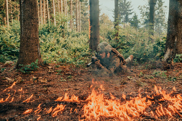 Modern warfare soldier surrounded by fire, fight in dense and dangerous forest areas