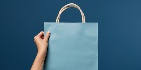 Shopping bag in woman's hand on blue background. Mockup design with blank space. Add text or logo. Generative Ai