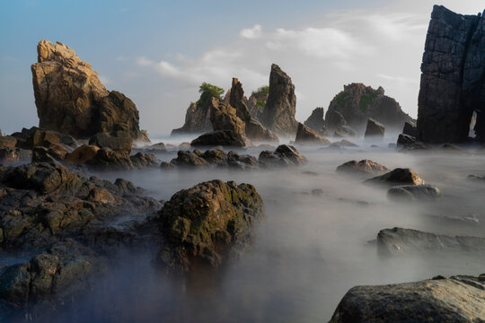 photo of pantai batu layar or pantai gigi hiu at kelumbayan tanggamus lampung, high quality images good for background. long exposure shoot on exotic beach. summer natural rocks corals daylight