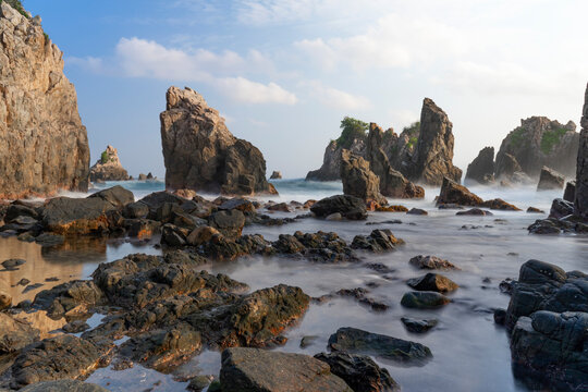 photo of pantai batu layar or pantai gigi hiu at kelumbayan tanggamus lampung, high quality images good for background. long exposure shoot on exotic beach. summer natural rocks corals daylight