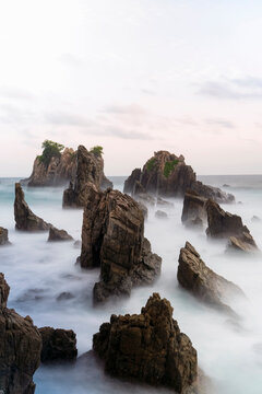 photo of pantai batu layar or pantai gigi hiu at kelumbayan tanggamus lampung, high quality images good for background. long exposure shoot on exotic beach. summer natural rocks corals daylight