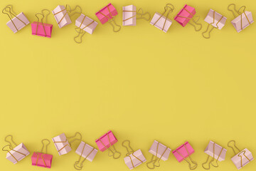 Pink binders lie in a chaotic order on a yellow background. View from above. School concept.