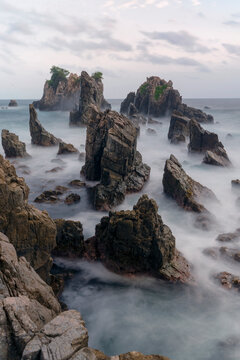 photo of pantai batu layar or pantai gigi hiu at kelumbayan tanggamus lampung, high quality images good for background. long exposure shoot on exotic beach. summer natural rocks corals daylight