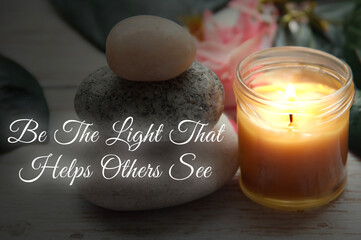 Motivational and inspirational quote - Be the light that helps others see text with zen stones background. Motivational concept.