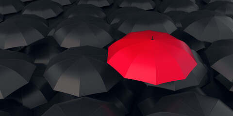 Red umbrella stand out from the crowd of many black umbrellas. Individual thinking concept.