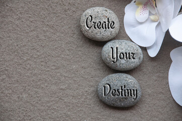 Top view of motivational quote text on rocks - Create your destiny. Motivational concept.